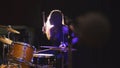 Girl rock musician - female drummer performing