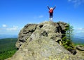 Girl on rock. Tourist on the top of Grosser Arber mountain in National park Bayerische Wald.