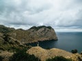 Girl on rocky shore north Mallorca, Balearic islands