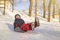 Girl roll on ice with snow slide and laugh. high quality