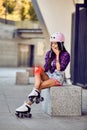 The girl on roller skates hurt knee in urban park Royalty Free Stock Photo