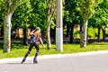 A girl on roller skates is riding on the road Royalty Free Stock Photo