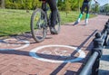 Girl roller-skating and bicycler on the bike path