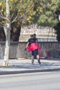 Girl rollerblading in the city, using bike lane in Seville, Spain