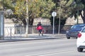 Girl rollerblading in the city, using bike lane in Seville, Spain