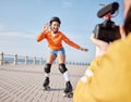 Girl, rollerskates and smile for camera, boardwalk and fun by ocean, sea and outdoors for hobby. Active person, skating Royalty Free Stock Photo