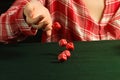 Girl rolling red dice fall on a table Royalty Free Stock Photo