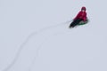 Girl rolls down a snow hill on an inflatable tubing Royalty Free Stock Photo