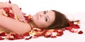 Girl in rose petal. Spa beautician. Royalty Free Stock Photo