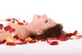 Girl in rose petal. Spa resort. Royalty Free Stock Photo