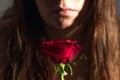 Girl with a rose with water drops in her hand. Royalty Free Stock Photo