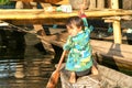 Girl on rowing a boat at the village of Maing Thauk