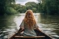 Girl rowing wooden boat in river