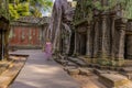 A girl in the ruins of Ta Prohm temple in Angkor complex, Cambodia