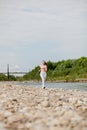 Girl runner running by riverbank . Healthy fitness woman jogging outdoors Royalty Free Stock Photo