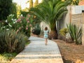 Girl running in the distance on a park path Royalty Free Stock Photo