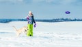 Girl running with dog in snow Royalty Free Stock Photo