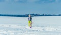 Girl running with dog in snow Royalty Free Stock Photo