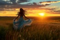 girl running through a field of tall grass at sunset, with her dress flowing in the breeze Royalty Free Stock Photo