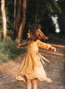 Girl running on the forest  on summer sunset. Beautiful little kid girl dancing. Summer fun outdoors Royalty Free Stock Photo