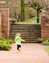 Girl running through a garden