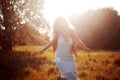 Girl is running out. Young woman in field, feel freedom and happiness. Casual style. Royalty Free Stock Photo