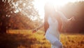 Girl is running out. Young woman in field, feel freedom and happiness. Casual style. Face in sunlight Royalty Free Stock Photo