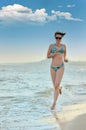 The girl running on seacoast Royalty Free Stock Photo
