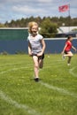 Girl running in sports race. Royalty Free Stock Photo