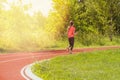 Girl running on school stadium track