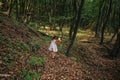 Girl running in the woods holding a toy bear in hand Royalty Free Stock Photo