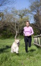 Girl running with your dog Royalty Free Stock Photo