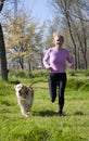 Girl running with your dog Royalty Free Stock Photo