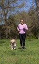 Girl running with your dog Royalty Free Stock Photo