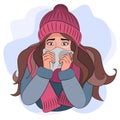 A girl with a runny nose in warm clothes, a hat and a scarf