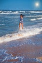 Girl runs along the beach in the waves, happy state of mind Royalty Free Stock Photo