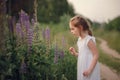 The girl runs along the forest road. Summer evening field and child Royalty Free Stock Photo