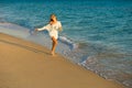 Girl runs along the seashore Royalty Free Stock Photo