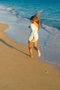 Girl runs along the surf line Royalty Free Stock Photo