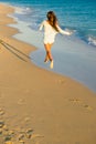 Girl runs along the surf line Royalty Free Stock Photo