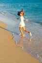 Girl runs along the surf line Royalty Free Stock Photo