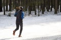 A girl runs around the Park in winter. Fitness on the street Royalty Free Stock Photo