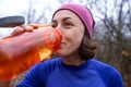 Girl drinks water after jogging Royalty Free Stock Photo