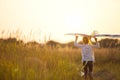 A girl runs into a field with a kite, learns to launch it. Outdoor entertainment in summer, nature and fresh air. Childhood, Royalty Free Stock Photo