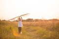 A girl runs into a field with a kite, learns to launch it. Outdoor entertainment in summer, nature and fresh air. Childhood, Royalty Free Stock Photo