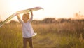 A girl runs into a field with a kite, learns to launch it. Outdoor entertainment in summer, nature and fresh air. Childhood, Royalty Free Stock Photo