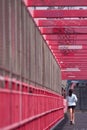 Girl runs over the Williamsburg bridge. Royalty Free Stock Photo