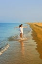 The girl runs on a sandy beach