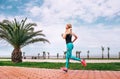 Girl runs on the sea embankment. Active life style