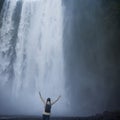 Girl runs to the skogafoss waterfall Royalty Free Stock Photo